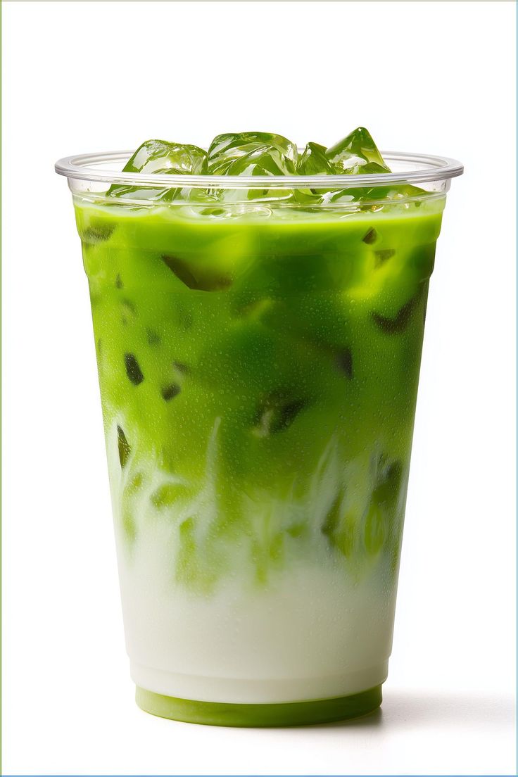 Iced matcha latte in a clear cup with layered green matcha and creamy milk